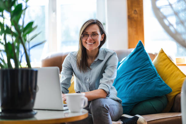 istock Young woman using a laptop at home 1399446983