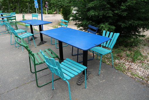Colourful chairs and tables at a park