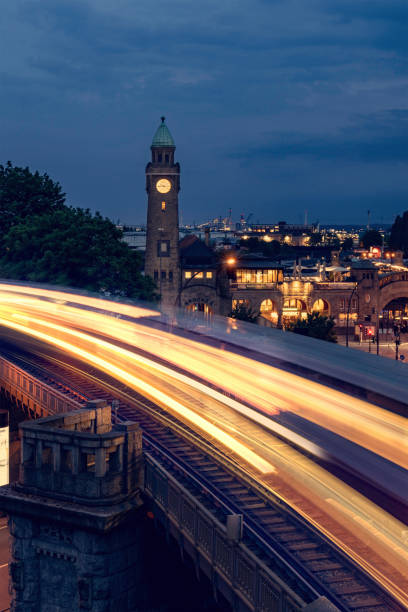 st. pauli, landungsbrücken with lights of the subway in hamburg at the blue hour. - gangplank imagens e fotografias de stock