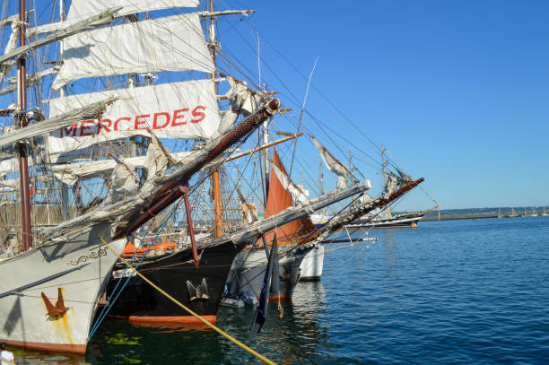 Aberdeen, Scotland - Jul 22nd 2025: People watching from the shore as the sailing ship Dar Młodzieży leaves Aberdeen harbour in Scotland after its visit during the Tall Ships Races 2025.\nDar Młodzieży (Polish: Gift of the Youth) is a Polish sail training ship designed by Zygmunt Choreń, and was launched in November 1981 at the Gdańsk Shipyard, Poland.