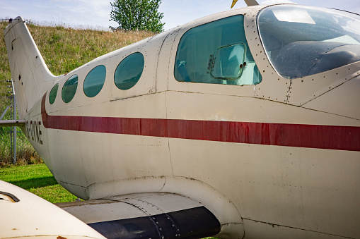 Close up of cockpit windows and along the fuselage of a small airplane