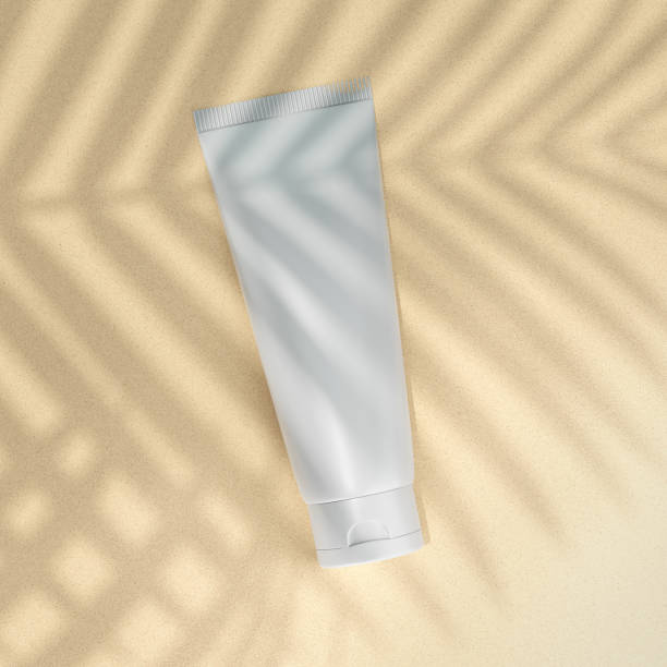 istock Blank packaging of cosmetics on the sand with shadow from palm leaves. Sunscreen mockup. 3d illustration. 1399455536