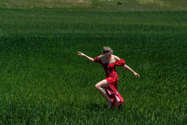 Happy Young Woman at Fields in Springtime