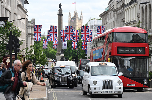 Central London traffic around Piccadilly Circus decked with Platinum Jubilee British flags. London, UK