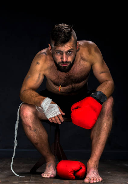 istock boxer getting ready for a fight wrapping tape around his hands 1399459049