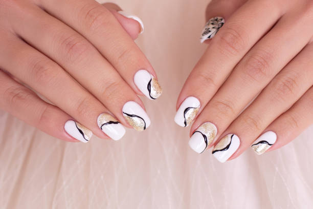 istock Female hands with golden manicure nails 1399465791