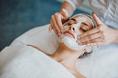 Close-up portrait of anorganic facial mask application at spa salon. Facial treatment. Skin care. Health care. Rejuvenation treatment.
