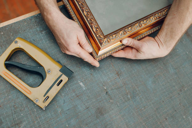 Framing Workshop. Making baguette handmade picture frame at studio Framing Workshop. Making assembly stapler brackets baguette handmade picture frame at studio. hand cropping photos stock pictures, royalty-free photos & images