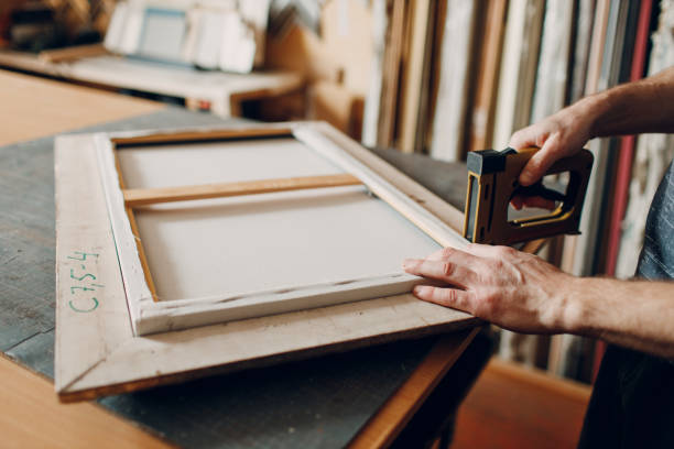 Framing Workshop. Making baguette handmade picture frame at studio Framing Workshop assembling. Stapler ruler and frames baguette handmade picture frame at studio table hand cropping photos stock pictures, royalty-free photos & images
