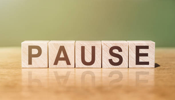 istock Wooden Blocks with the text: Pause on a green-brown background 1399472794