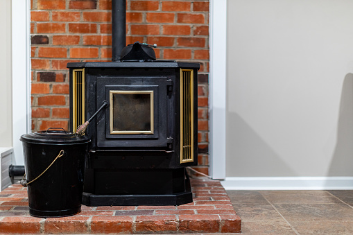 Wood burning stove on a brick foundation. Common things in and around the house