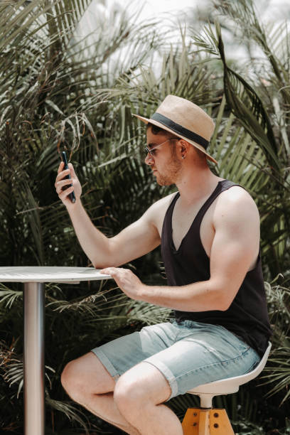 istock Boy sitting on a stool looking at the mobile phone 1399477067