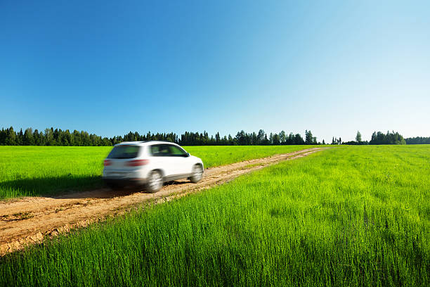istock spring field and blured car on ground road 139948018