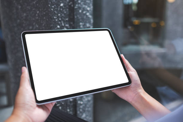 istock Mockup image of a woman holding digital tablet with blank white desktop screen 1399484529
