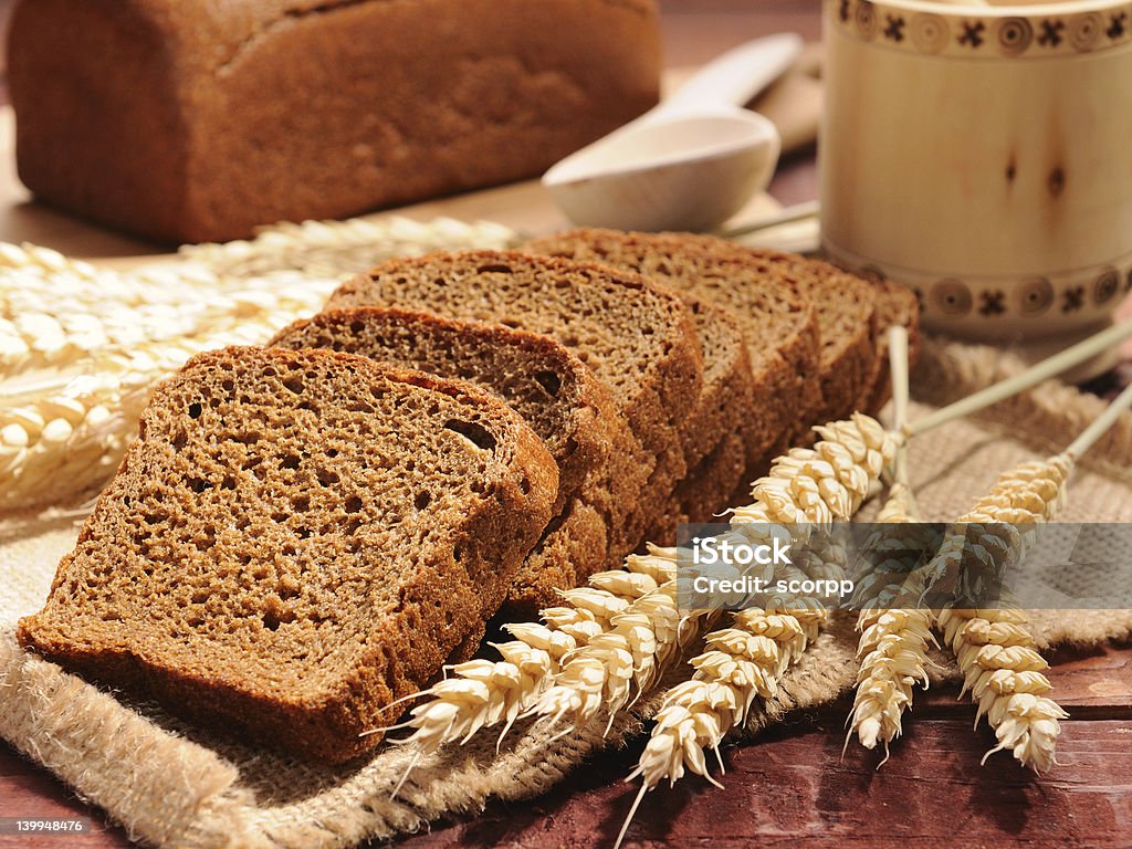 The Bread sliced bread and wheat on the wooden table Bread Stock Photo