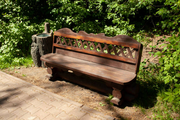 istock Park tree stump bench with stump urn 1399489360