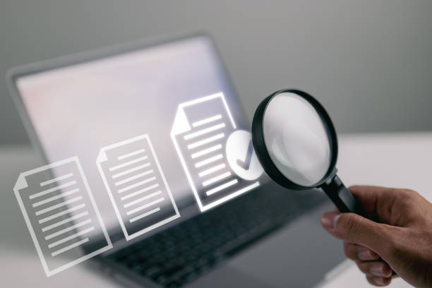 Documents and magnifying glass. Confirmed or approved document on laptop computer. Documents and magnifying glass. Confirmed or approved document on laptop computer. report document stock pictures, royalty-free photos & images