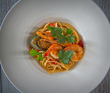 Tasty and a bit spicy pasta with shrimps,  mussel and cherry tomatoes.