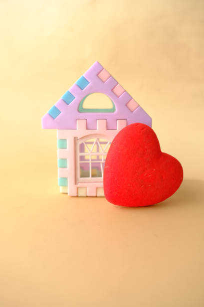istock a house and heart shape symbol on color background 1399494511