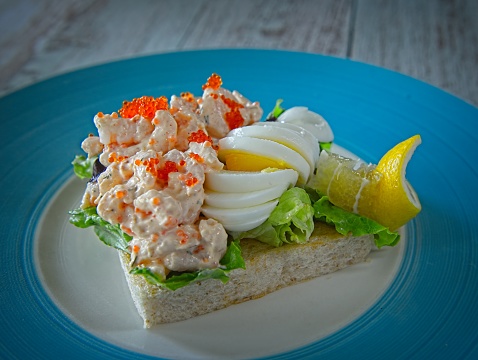 Toast Skagen is a Swedish starter and food dish. It consists of pieces of toasted bread and a prawn salad called skagenröra, typically made with mayonnaise, boiled egg, sourcream and garnished with roe.
