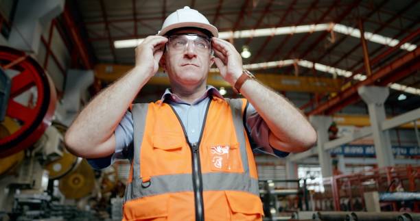 istock Senior industrial engineer or technician have proficient, prepare to work in production line, wear personal protective equipment, hard hat, safety glasses, working at heavy manufacturing factory. 1399497212