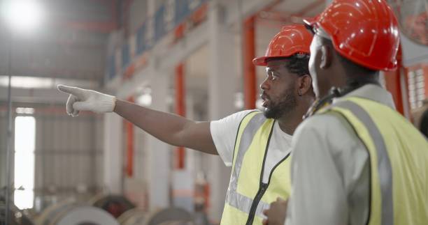 istock Team industrial engineer or or technician, wear personal protective equipment talking and planning to operation of machines, monitor production line process of assembly part, production control of machine in manufacturing factory. 1399497460