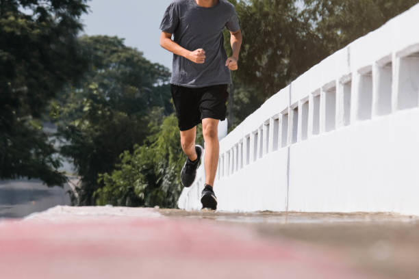 istock Young man runner feet running on the road be running for exercise. healthy exercise concept. 1399498619