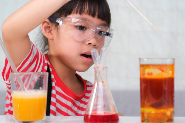 istock Children are learning and doing science experiments in the classroom. Little girl playing science experiment for home schooling. Easy and fun science experiments for kids at home. 1399498692