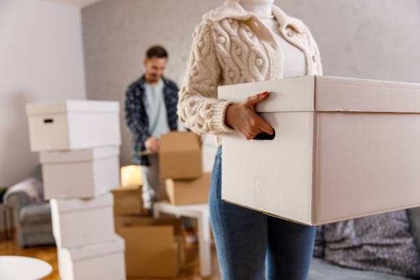 istock Couple packing boxes and preparing to move into new home 1399499818