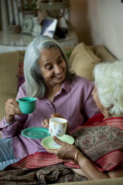 istock Two old women drinking coffee at home 1399501486