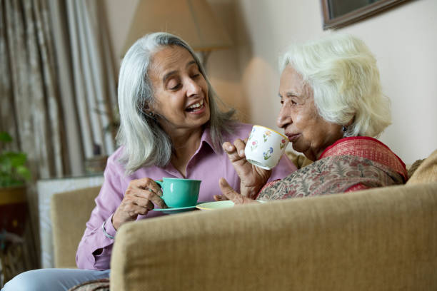 istock Two old women drinking coffee at home 1399502029