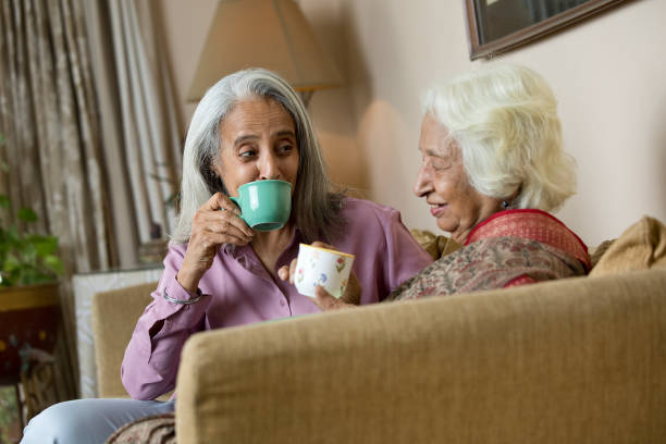 istock Two old women drinking coffee at home 1399502066