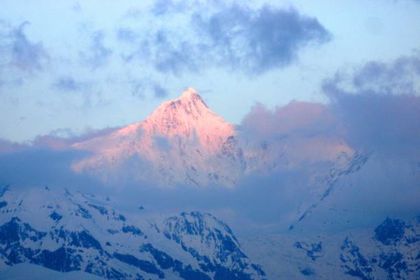 At sunrise moment in Kawagarbo Peak of Meili Snow Mountain Meili Snow Mountain is located at the junction of Yunnan and Tibet.The main peak of Kawagarbo is one of the four holy mountains in all Tibetan areas, which attracts many believers to pilgrimage and worship every year.Meili Snow Mountain is also rated as the most beautiful snow mountain in China, attracting many tourists to visit. meili stock pictures, royalty-free photos & images