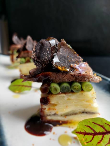 Potato Pave with Mushroom Duxelle, Roast Beef Fillet sliced ,Green Beans ,Summer Truffle ,aromatic Rosemary Flower