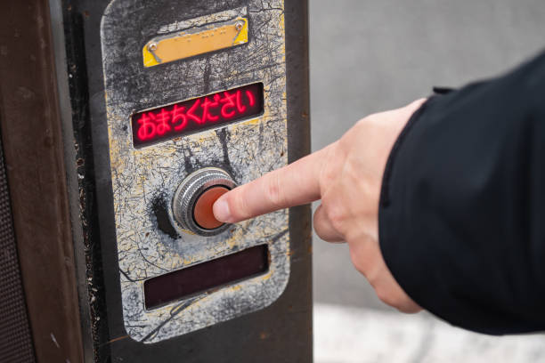 istock A finger pressing the red switch on the pedestrian crossing. Translation: Please wait. 1399503626