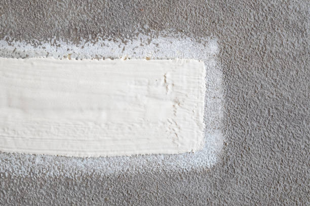 istock Driveway or road repair patch with waterproofing primer liquid, top view. 1399510997