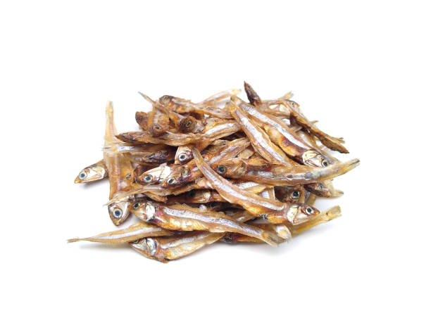 istock dried anchovy fish isolated on white background, selective focus 1399513072