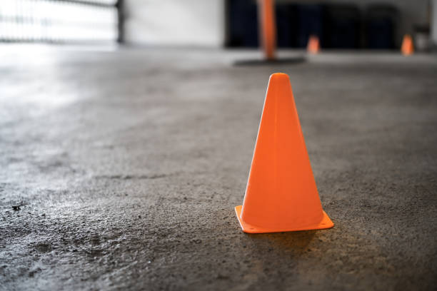 istock Safety cone on driveway in parking garage while repair work is in progress or cleaning. 1399513770
