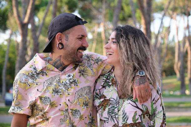 istock Young cool tattooed couple looking each other and laughing. 1399514999