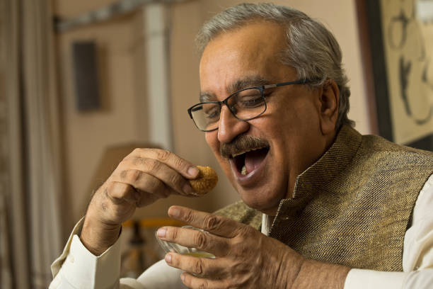 istock Man eating gol gappe or pani poori at home 1399515130