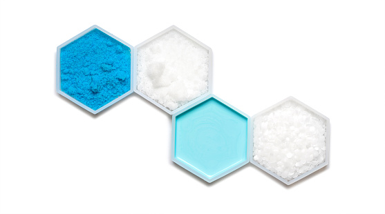 Chemical ingredient in hexagonal molecular shaped container. Copper (II) Sulfate, Sodium Hydroxide Pellets, Hair Conditioner and Polyethylene.
