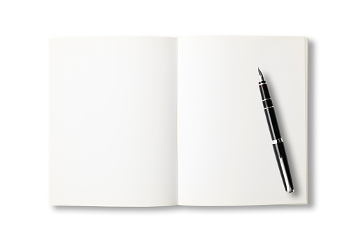 Overhead shot of opened blank book with fountain pen on white background.