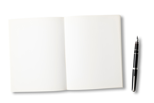 Overhead shot of opened blank book with fountain pen on white background.