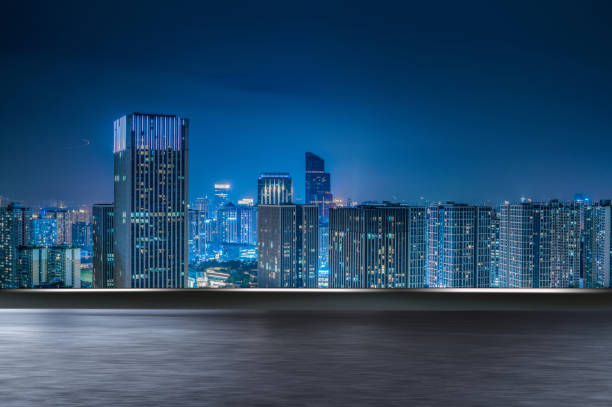 istock motion blurred asphalt road and modern cityscape at night. 1399519768