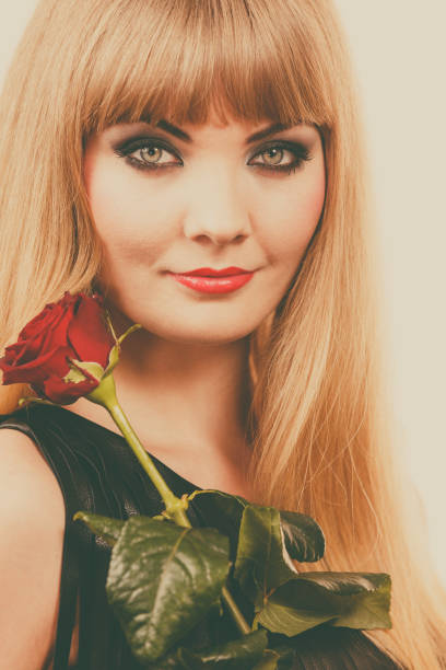 istock Beautiful young lady with red rose. 1399520175