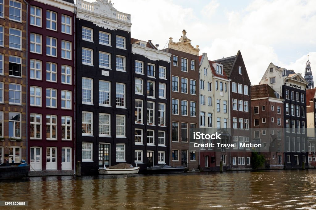 Amsterdam waterfront canal houses at Damrak Amsterdam waterfront canal houses at Damrak, The Netherlands Amsterdam Stock Photo