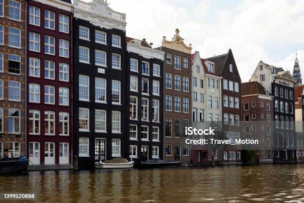 Amsterdam Waterfront Canal Houses At Damrak Stock Photo - Download Image Now - Amsterdam, Architecture, Building Exterior