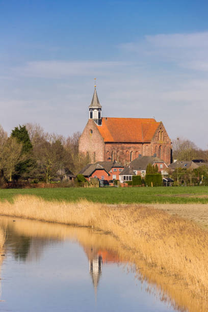 istock Historic Stefanus church with reflection in the river in Holwierde 1399520960