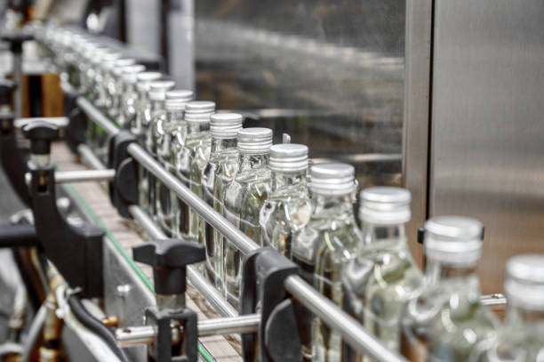 istock Closed glass bottles of upscale alcohol drink on conveyor 1399521685