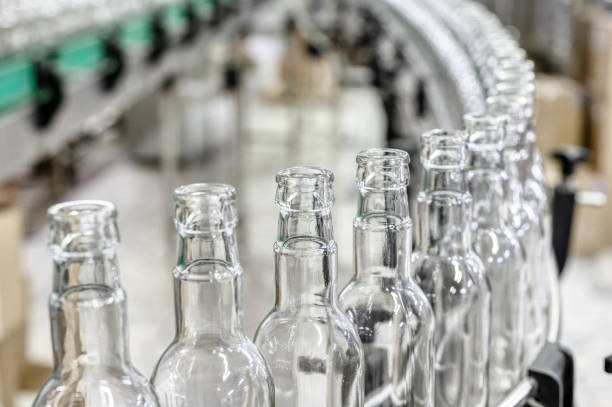 istock Conveyor with line of bottles for alcohol drinks in shop 1399521689